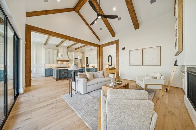 a dining room with wooden floor a chandelier a wooden table and chairs