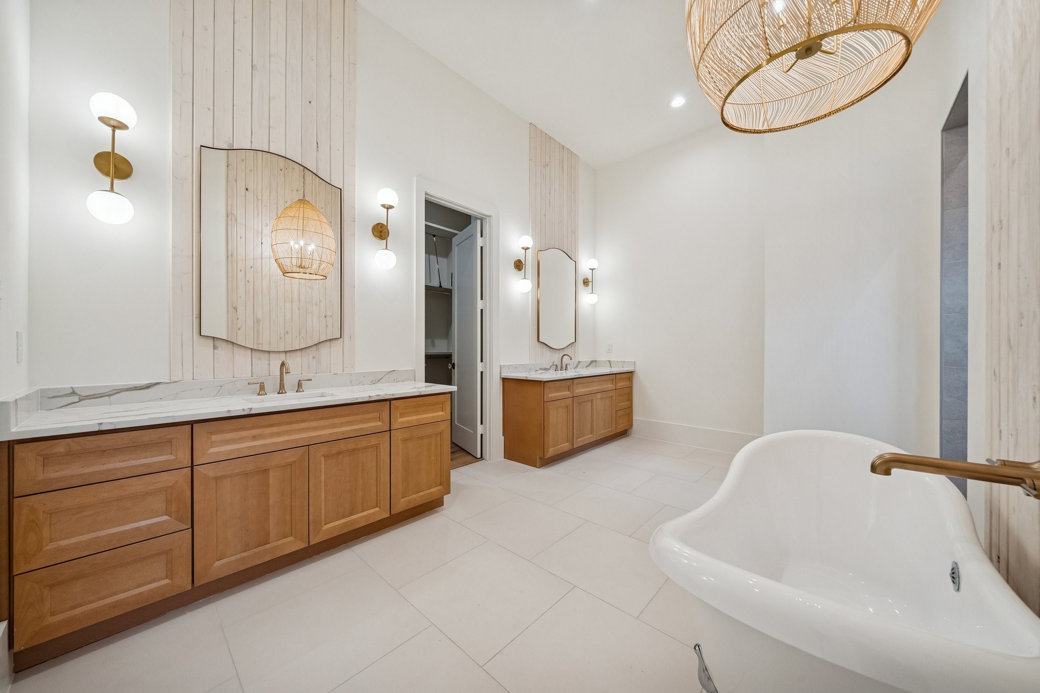 511 Graceland Street Houston, TX 77009 - Photo 9 of 10 The primary bathroom is luxuriously appointed from the clawfoot tub to the extended walk-in shower behind the tub wall. The closet is amazing and even has a hidden closet.