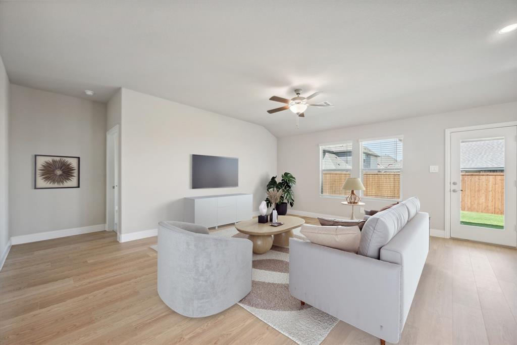 809 Sunflower Road Lavon, TX 75166 - Photo 13 of 32 a living room with furniture and a wooden floor
