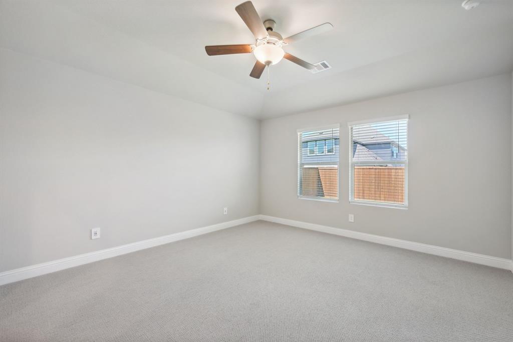 809 Sunflower Road Lavon, TX 75166 - Photo 23 of 32 an empty room with window and ceiling fan
