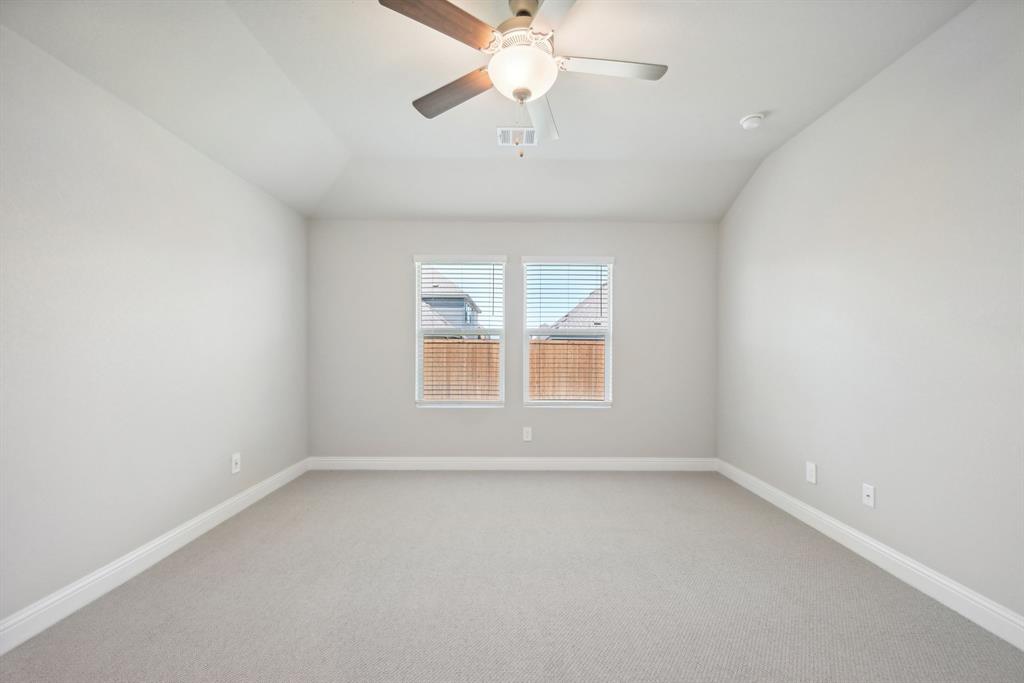 809 Sunflower Road Lavon, TX 75166 - Photo 25 of 32 an empty room with a window and a fan