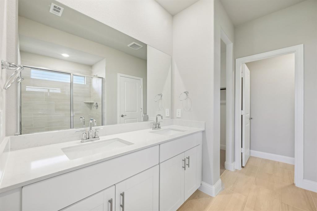 809 Sunflower Road Lavon, TX 75166 - Photo 26 of 32 a bathroom with double sink and a mirror