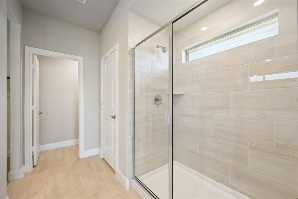 809 Sunflower Road Lavon, TX 75166 - Photo 27 of 32 a bathroom with a shower and a glass door