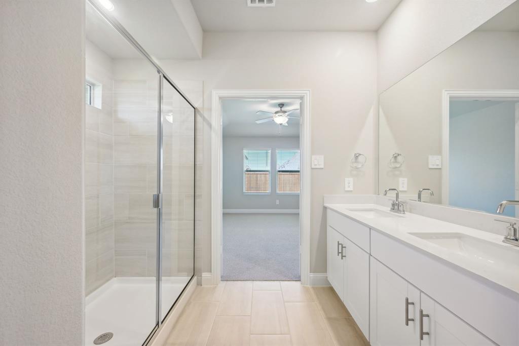 809 Sunflower Road Lavon, TX 75166 - Photo 28 of 32 a bathroom with a shower sink and mirror