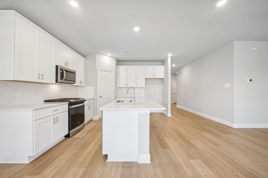 809 Sunflower Road Lavon, TX 75166 - Photo 4 of 32 a kitchen with stainless steel appliances granite countertop a sink stove and refrigerator