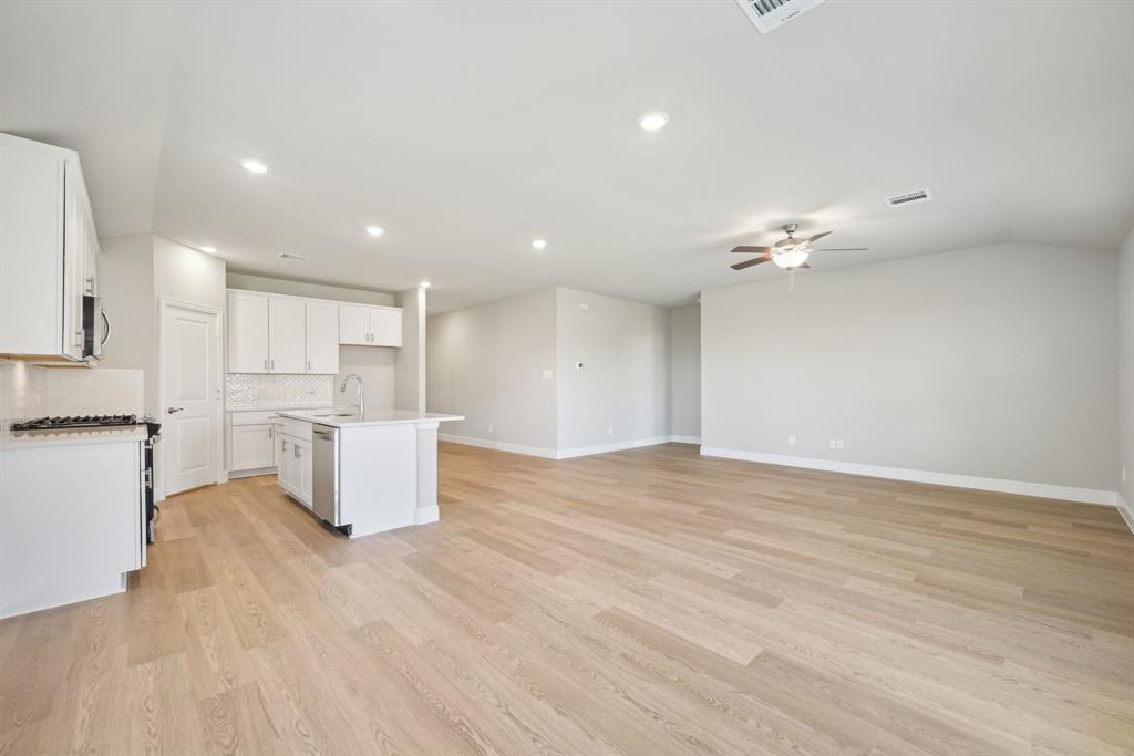 809 Sunflower Road Lavon, TX 75166 - Photo 8 of 32 a view of kitchen and empty room with wooden floor