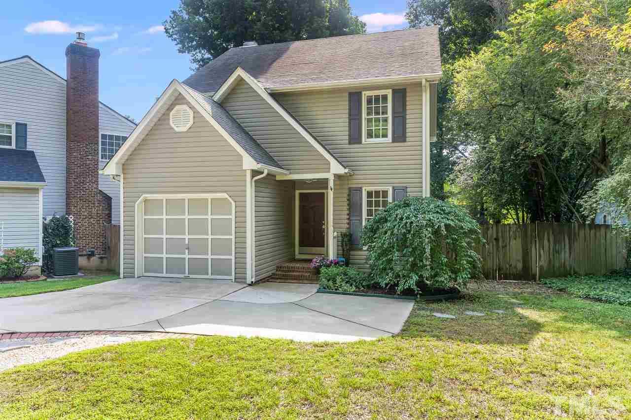 5504 Spring Pines Way Raleigh, NC 27616 - Photo 1 of 25 a front view of a house with a yard and potted plants