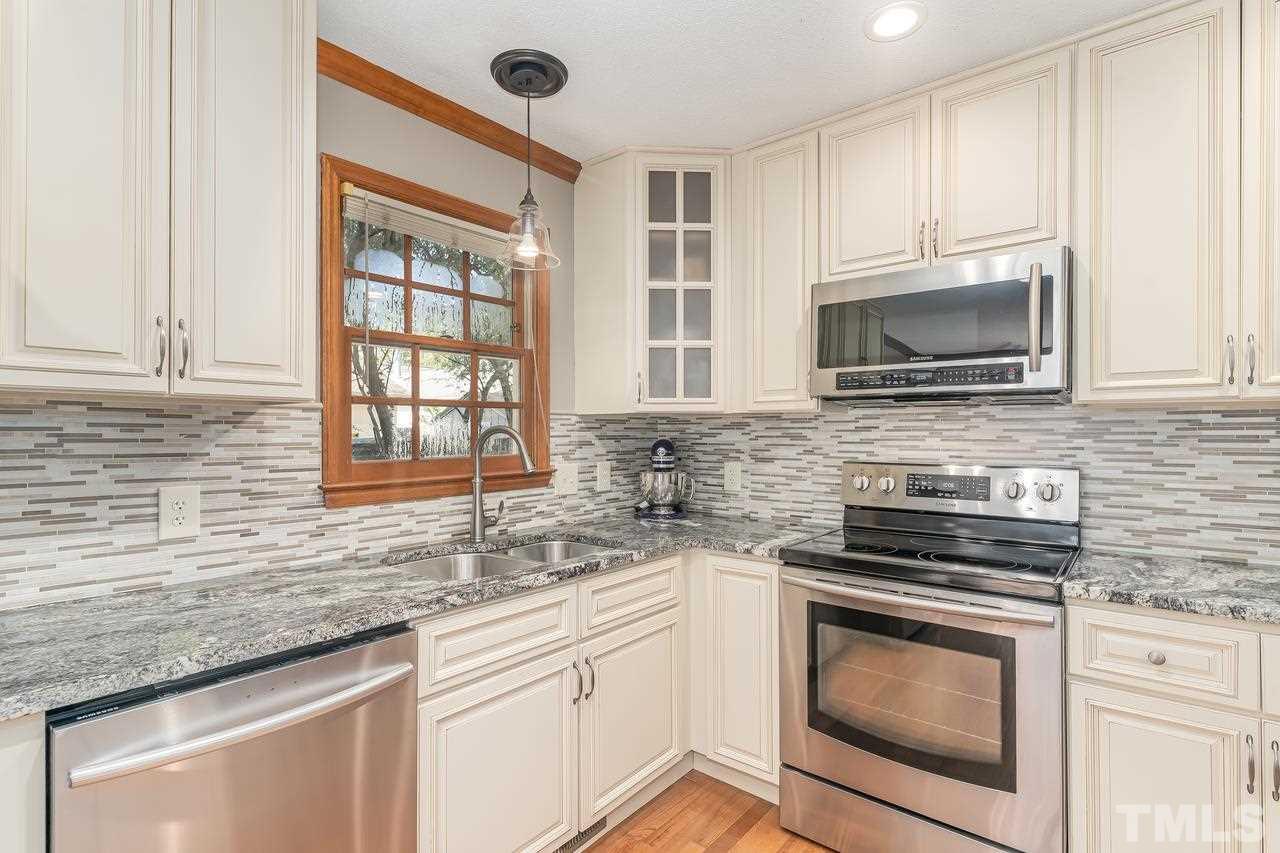 5504 Spring Pines Way Raleigh, NC 27616 - Photo 11 of 25 a kitchen with stainless steel appliances granite countertop white cabinets granite counter tops and a window