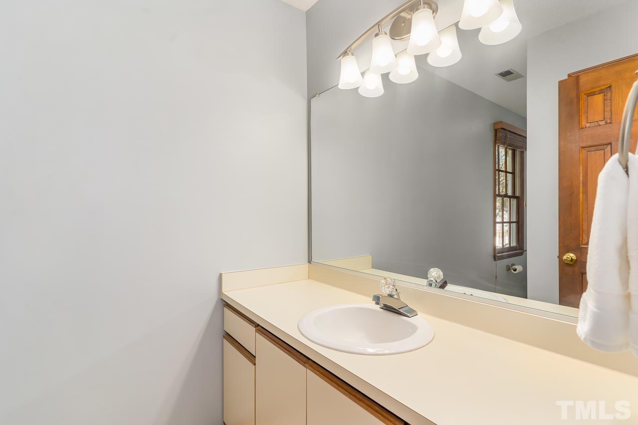 5504 Spring Pines Way Raleigh, NC 27616 - Photo 20 of 25 a bathroom with a sink and a mirror
