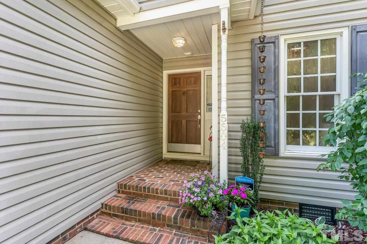 5504 Spring Pines Way Raleigh, NC 27616 - Photo 3 of 25 a view of a house with a door and a potted plant
