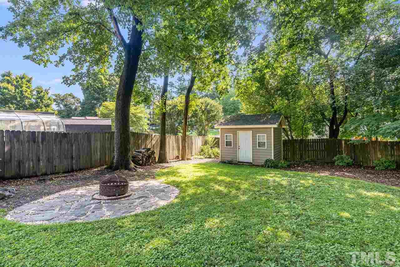 5504 Spring Pines Way Raleigh, NC 27616 - Photo 25 of 25 a view of a backyard with table and chairs and a large tree