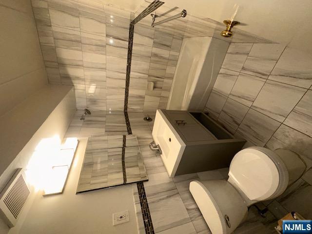 873 Main Street, Unit 2C Hackensack, NJ 07601 - Photo 11 of 19 a bathroom with a sink toilet and shower