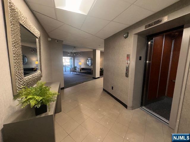 873 Main Street, Unit 2C Hackensack, NJ 07601 - Photo 18 of 19 a view of a hallway to the room with wooden floor