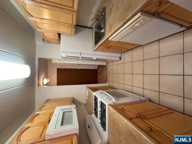 873 Main Street, Unit 2C Hackensack, NJ 07601 - Photo 9 of 19 a kitchen with a sink a stove and refrigerator