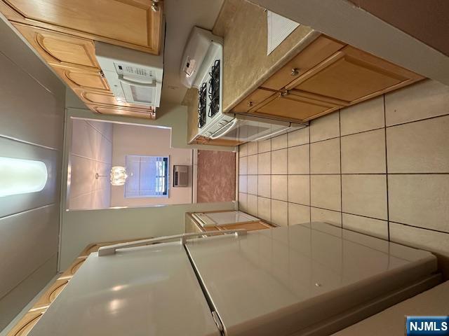 873 Main Street, Unit 2C Hackensack, NJ 07601 - Photo 10 of 19 a kitchen with a white cabinets and white appliances