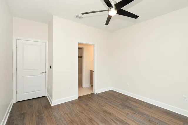 a view of an empty room with wooden floor