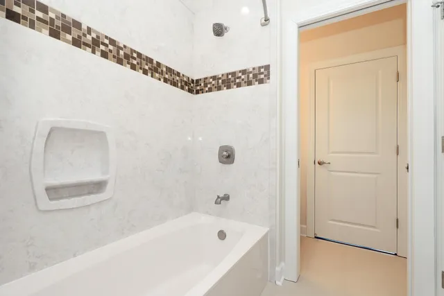 a bathroom with a bathtub and a window