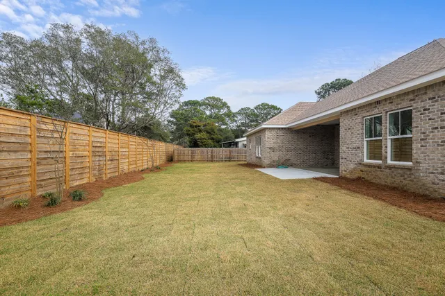 a view of a livingroom with a ceiling fan and window