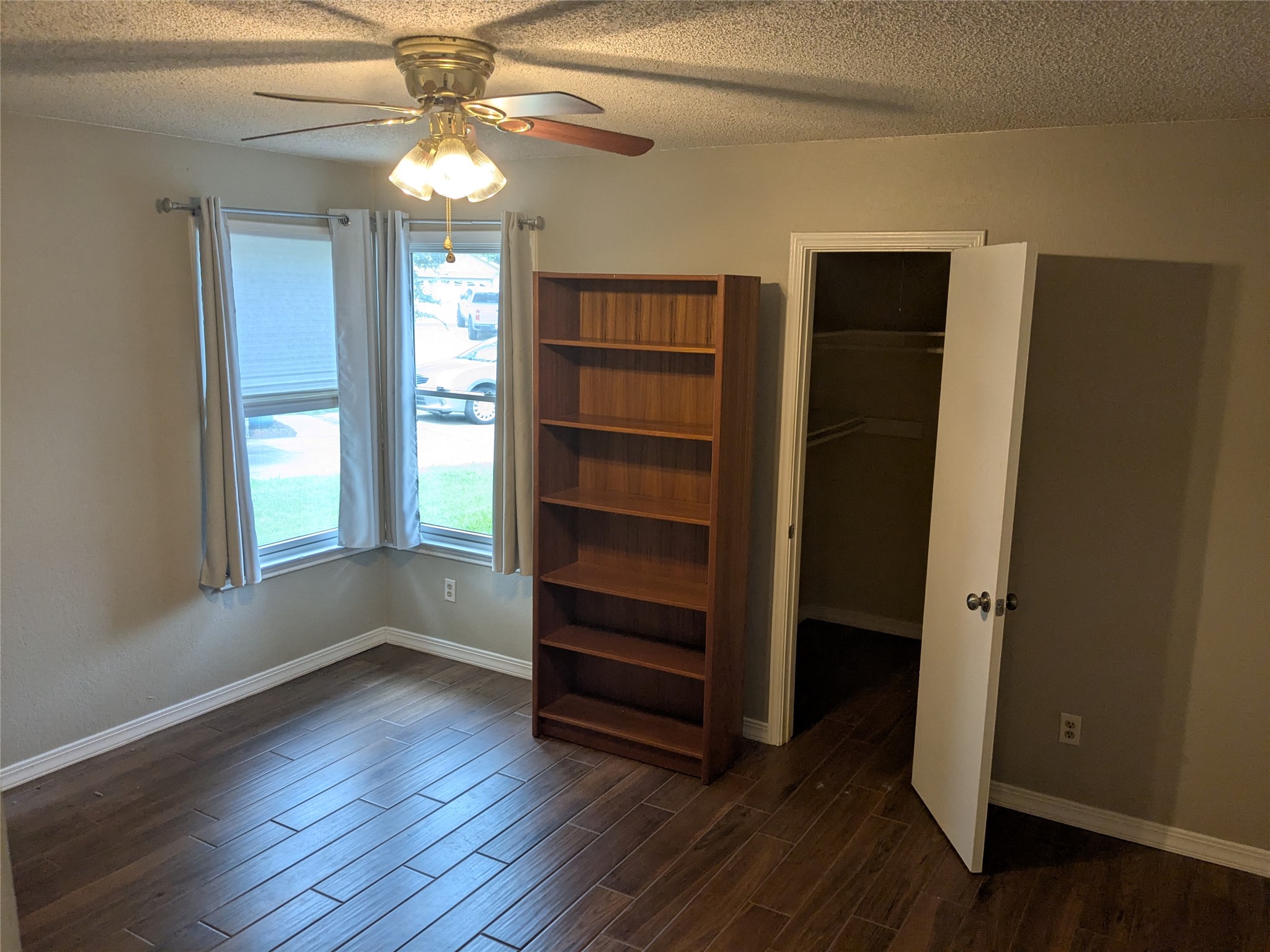 2502 Charla Circle Austin, TX 78728 - Photo 10 of 14 Well-lit sleeping quarters with a ceiling fan and convenient closet access.