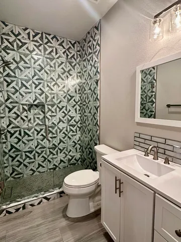 a bathroom with a sink toilet and shower