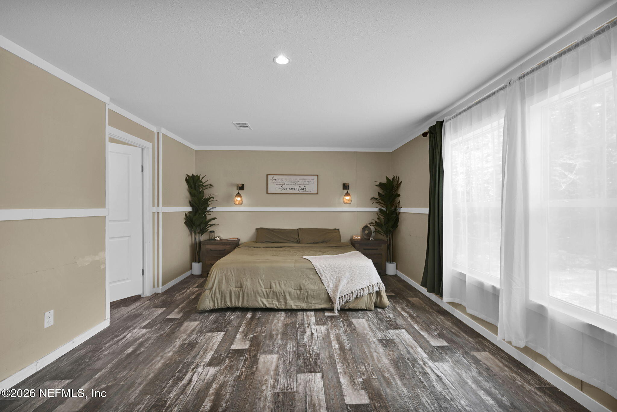 540783 Lem Turner Road Callahan, FL 32011 - Photo 29 of 36 a bedroom with a bed and wooden floor