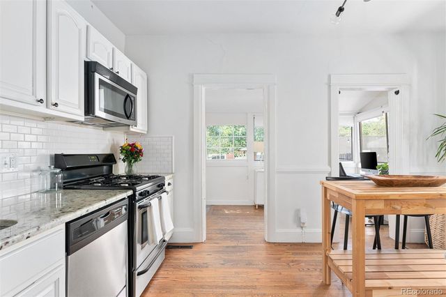 a kitchen with stainless steel appliances a stove microwave and a refrigerator
