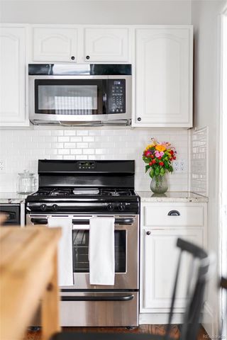 a stove top oven sitting inside of a kitchen