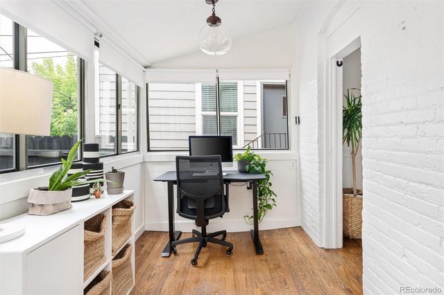 a view of a workspace with furniture and a potted plant