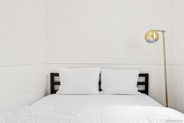 a bedroom with a bed and a night stand