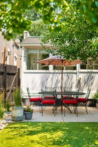 a view of pool with lawn chairs and a large tree