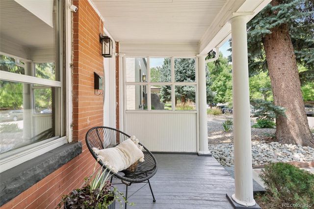 a view of a porch with furniture and wooden floor