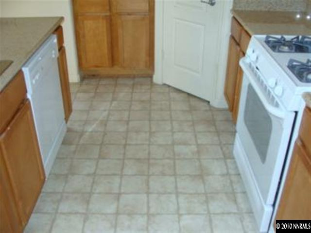 9050 Double R, Unit 922 Reno, NV 89521 - Photo 4 of 9 a view of a bathroom with a sink a washer and dryer