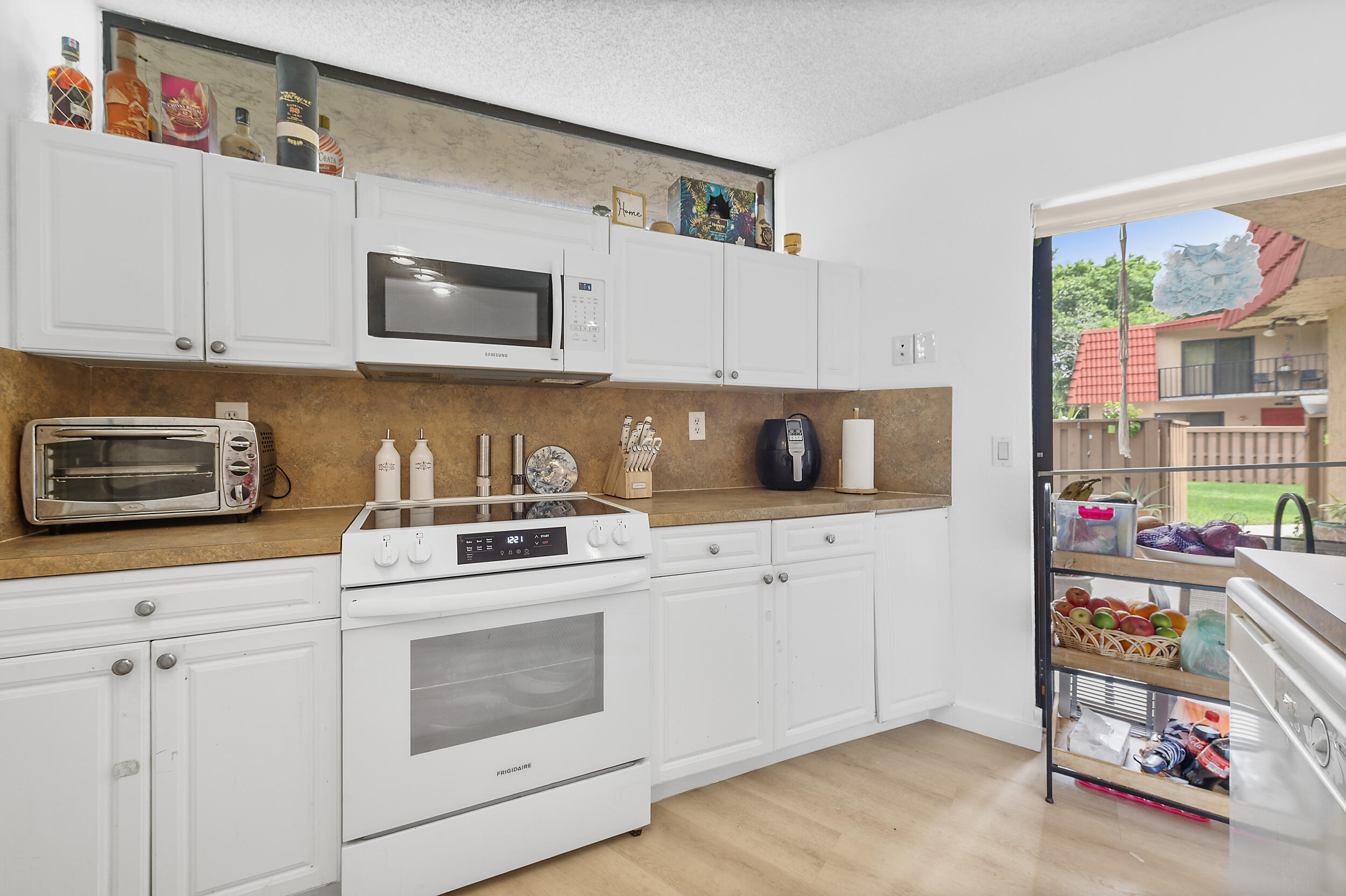 8141 Severn Drive, Unit B Boca Raton, FL 33433 - Photo 12 of 34 a kitchen with storage and utility