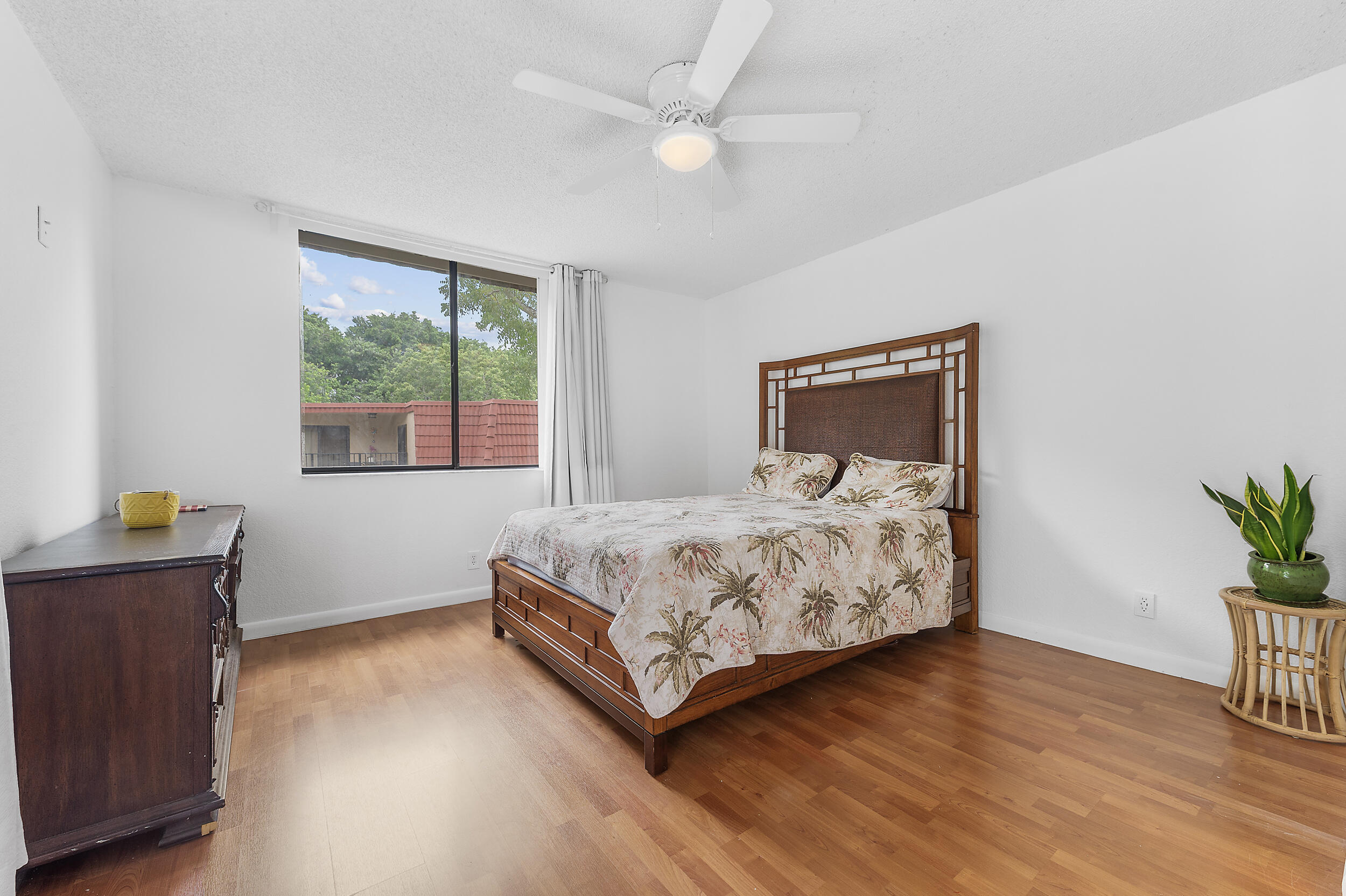 8141 Severn Drive, Unit B Boca Raton, FL 33433 - Photo 18 of 34 a bedroom with a bed and wooden floor
