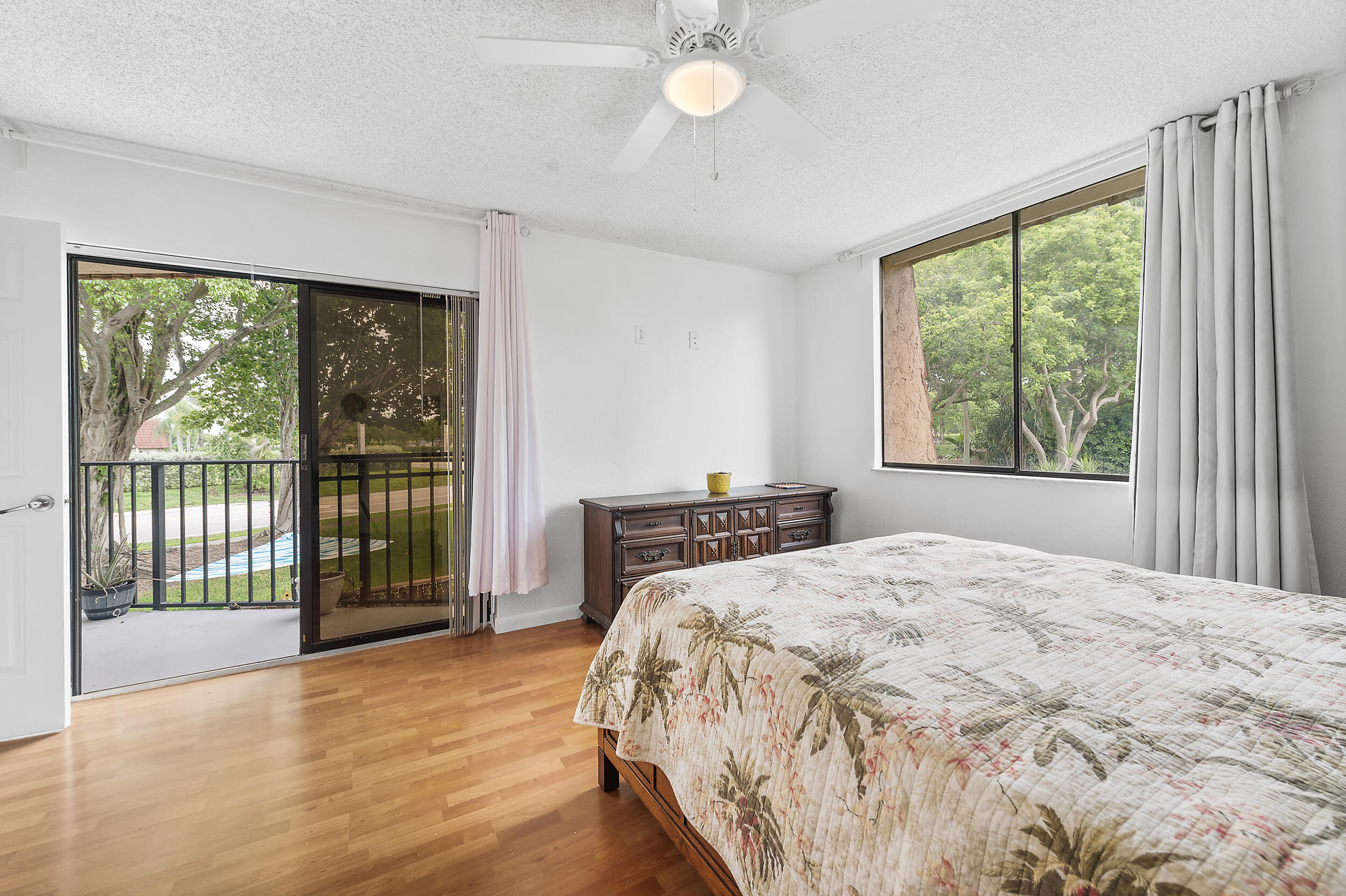 8141 Severn Drive, Unit B Boca Raton, FL 33433 - Photo 19 of 34 a bedroom with a large bed and a large window