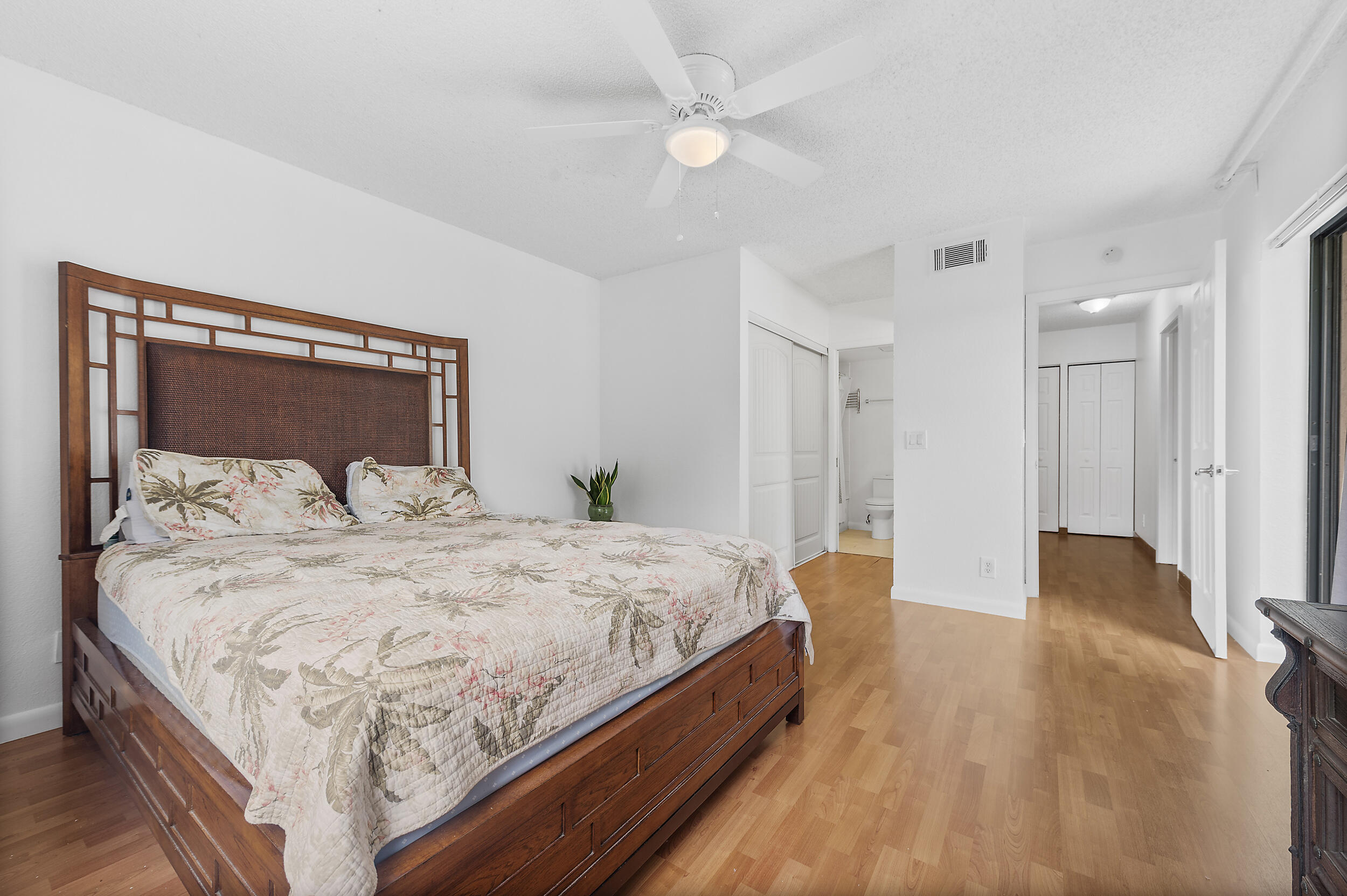 8141 Severn Drive, Unit B Boca Raton, FL 33433 - Photo 20 of 34 a bedroom with a bed and a mirror