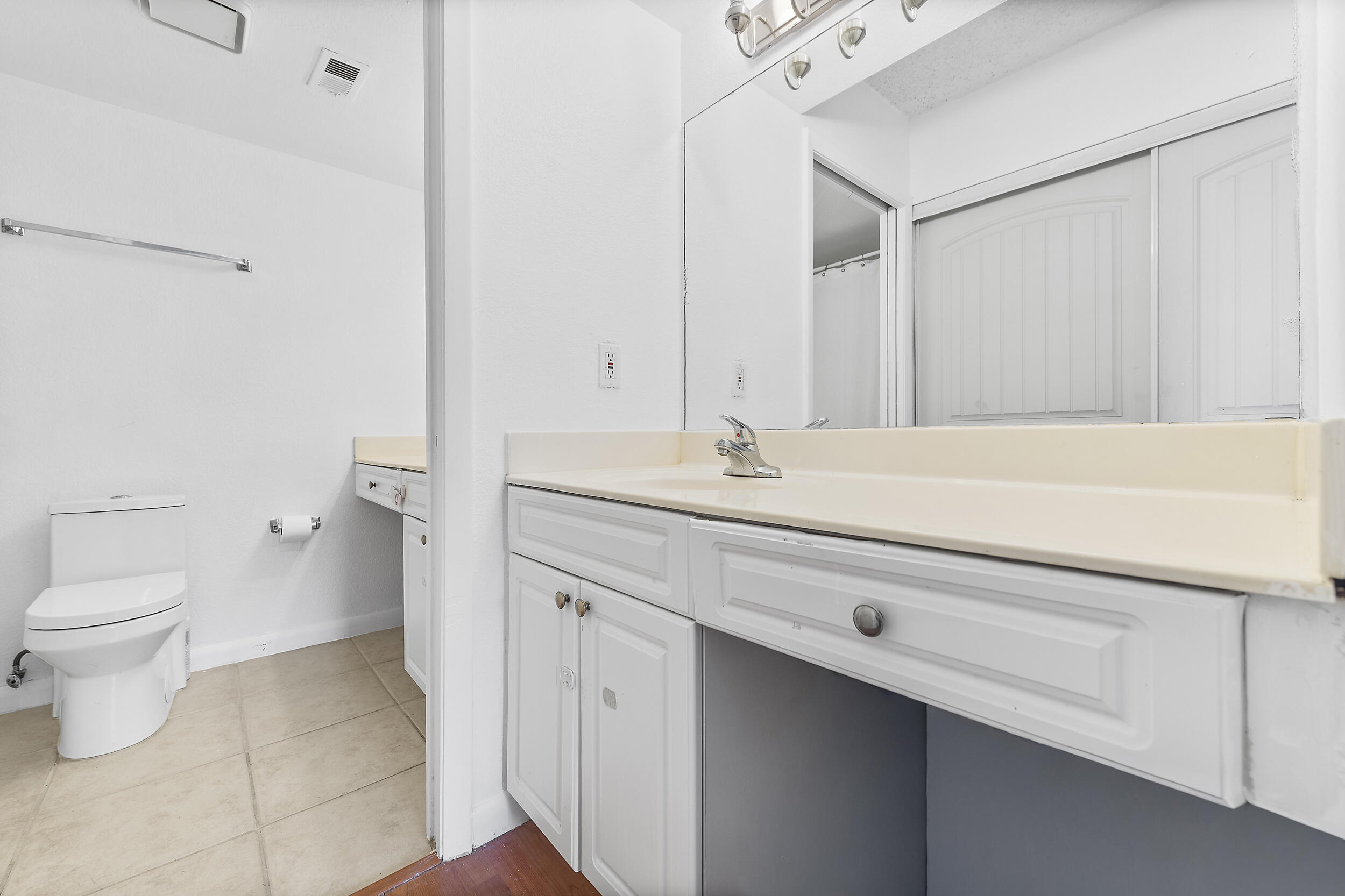 8141 Severn Drive, Unit B Boca Raton, FL 33433 - Photo 21 of 34 a bathroom with a sink a toilet and a mirror