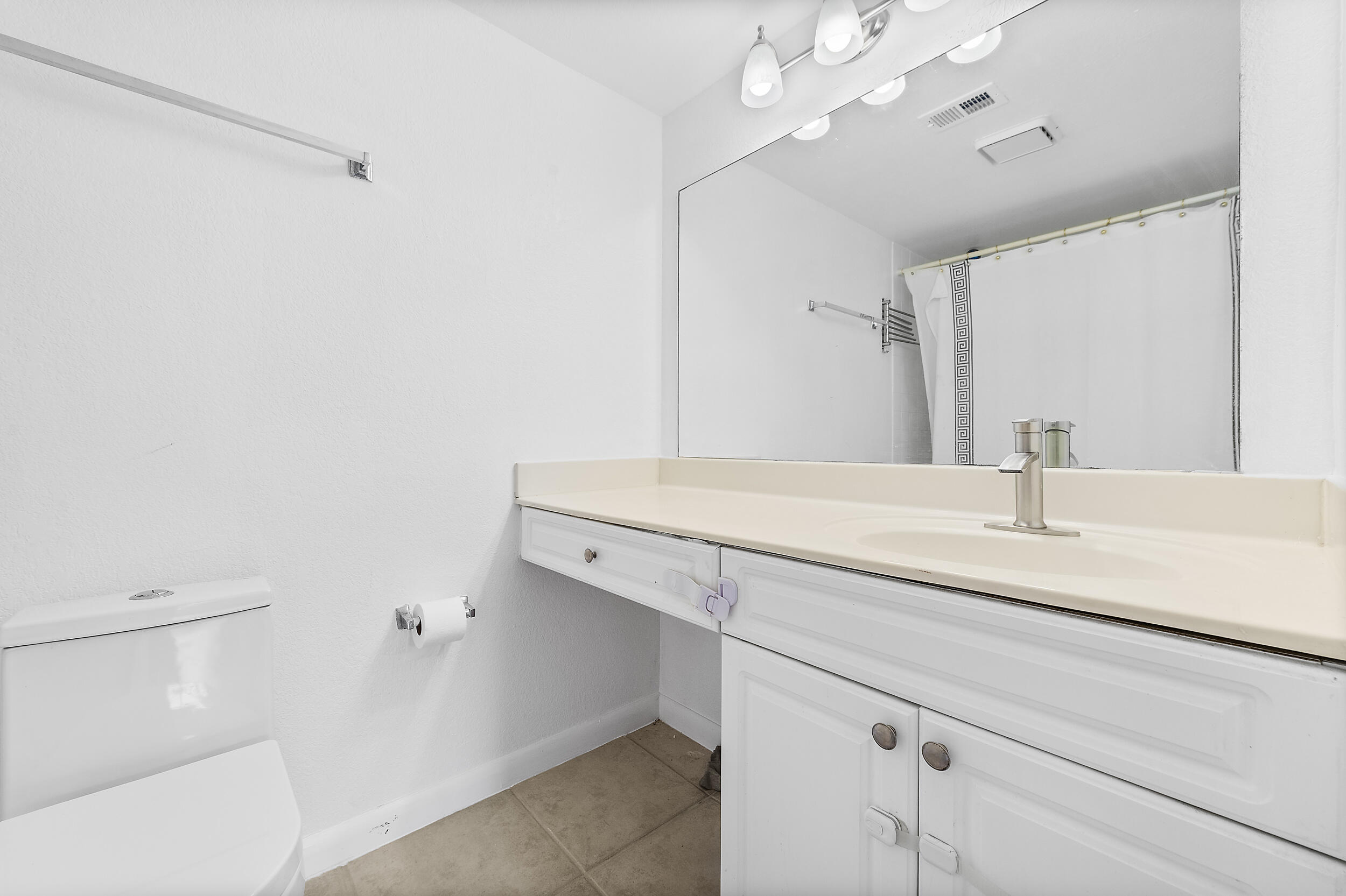 8141 Severn Drive, Unit B Boca Raton, FL 33433 - Photo 22 of 34 a bathroom with a sink and a mirror
