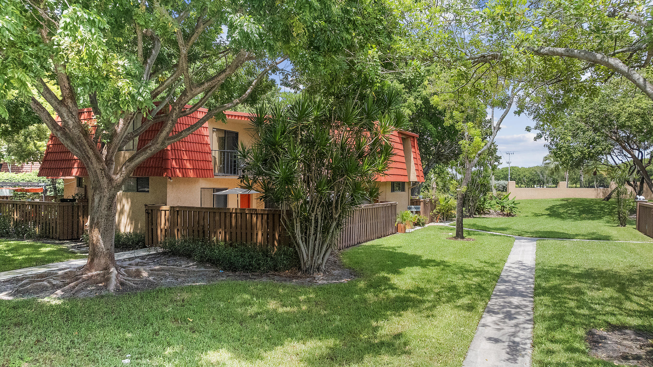 8141 Severn Drive, Unit B Boca Raton, FL 33433 - Photo 29 of 34 a backyard of a house with plants and large tree