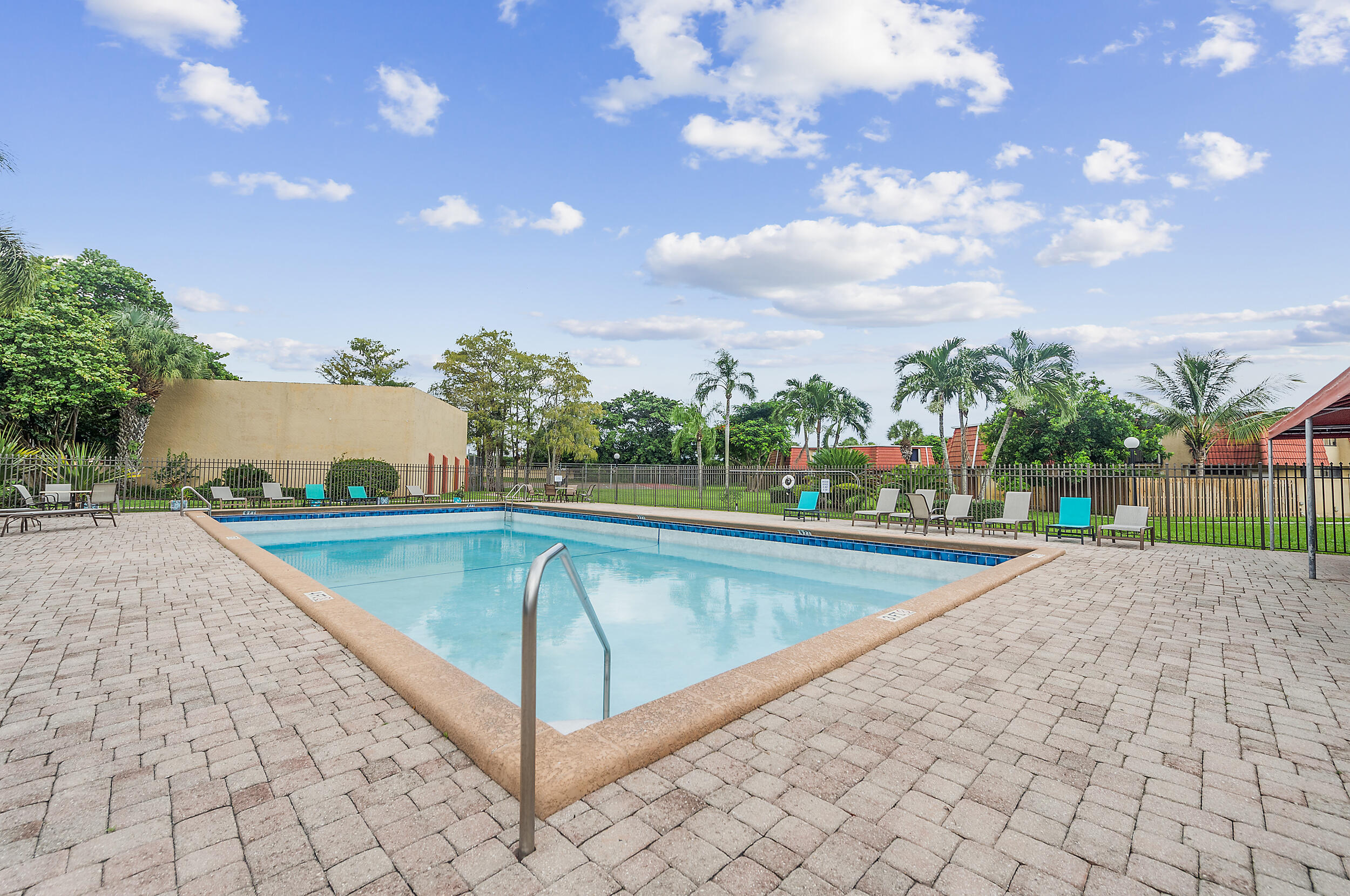 8141 Severn Drive, Unit B Boca Raton, FL 33433 - Photo 33 of 34 a view of a swimming pool with an outdoor seating and a yard