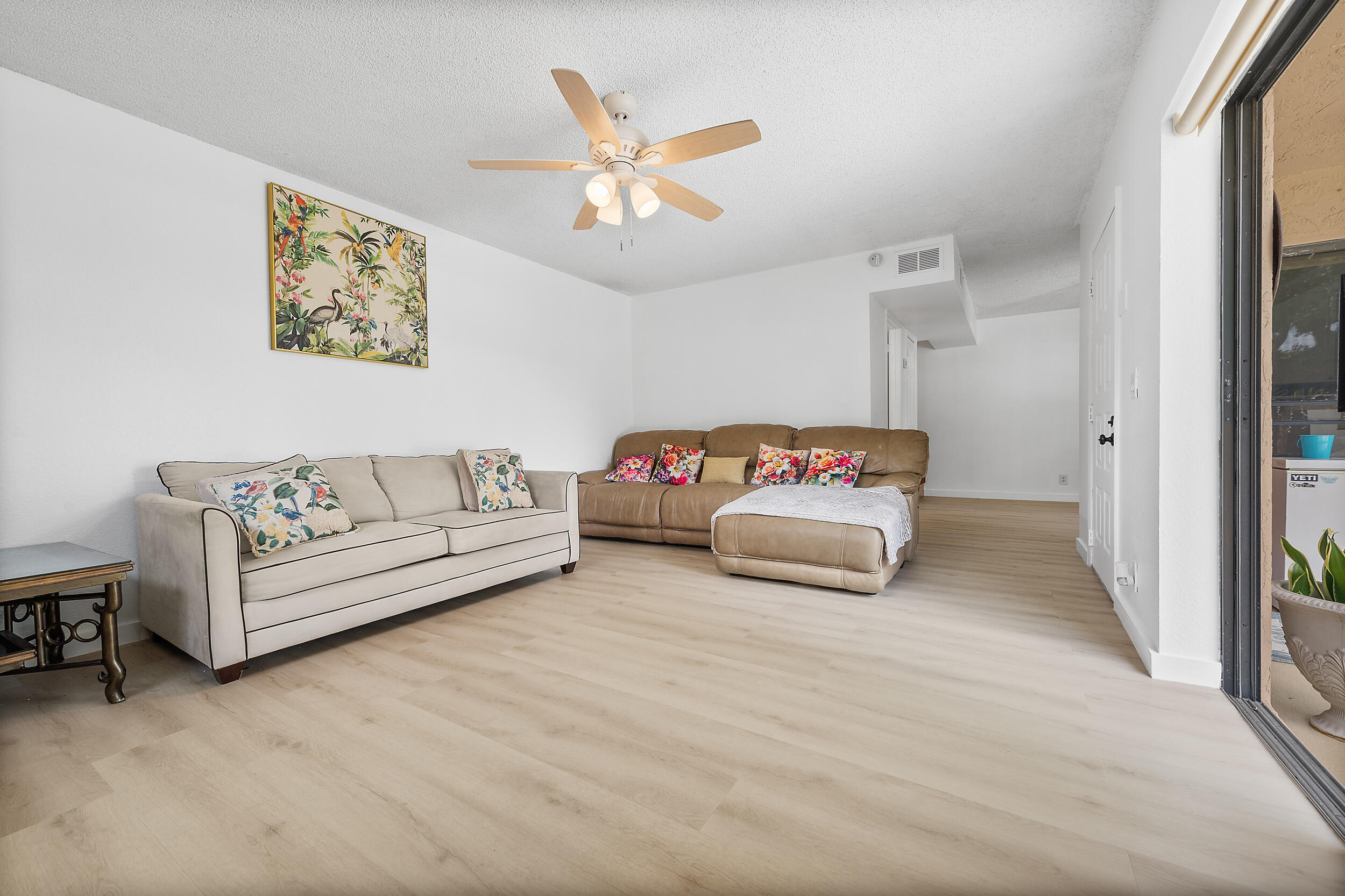 8141 Severn Drive, Unit B Boca Raton, FL 33433 - Photo 5 of 34 a living room with a bed and a ceiling fan