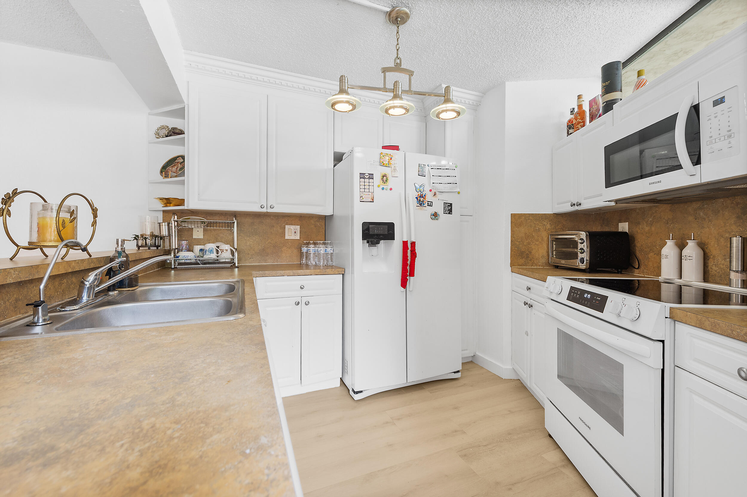 8141 Severn Drive, Unit B Boca Raton, FL 33433 - Photo 8 of 34 a kitchen with stainless steel appliances granite countertop a sink and a stove