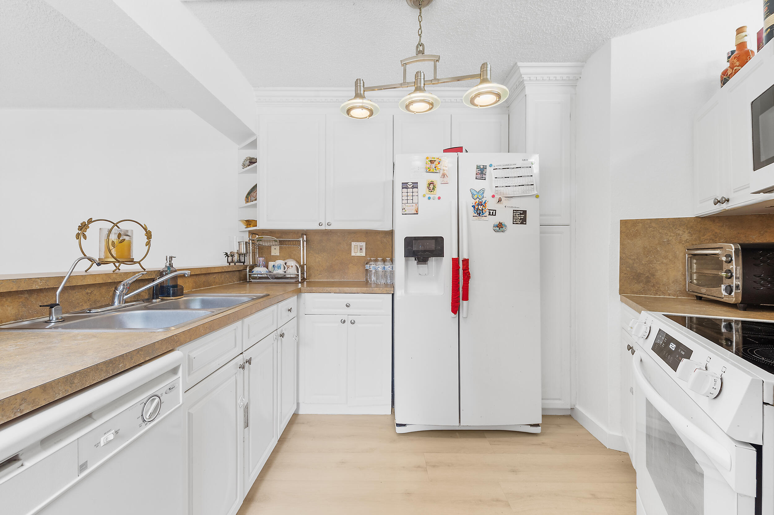 8141 Severn Drive, Unit B Boca Raton, FL 33433 - Photo 9 of 34 a kitchen with refrigerator and cabinets