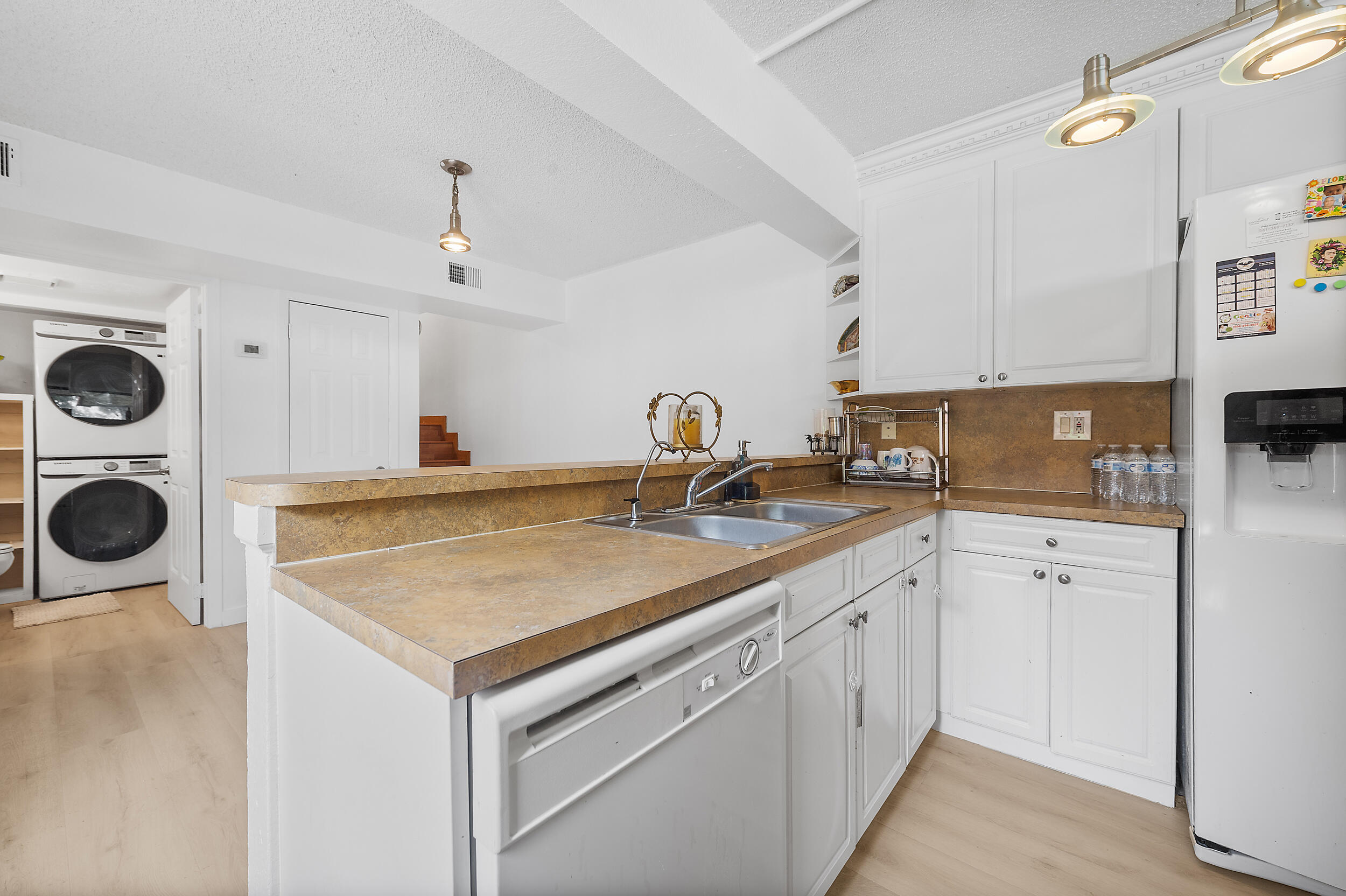 8141 Severn Drive, Unit B Boca Raton, FL 33433 - Photo 10 of 34 a kitchen with a sink a stove and cabinets