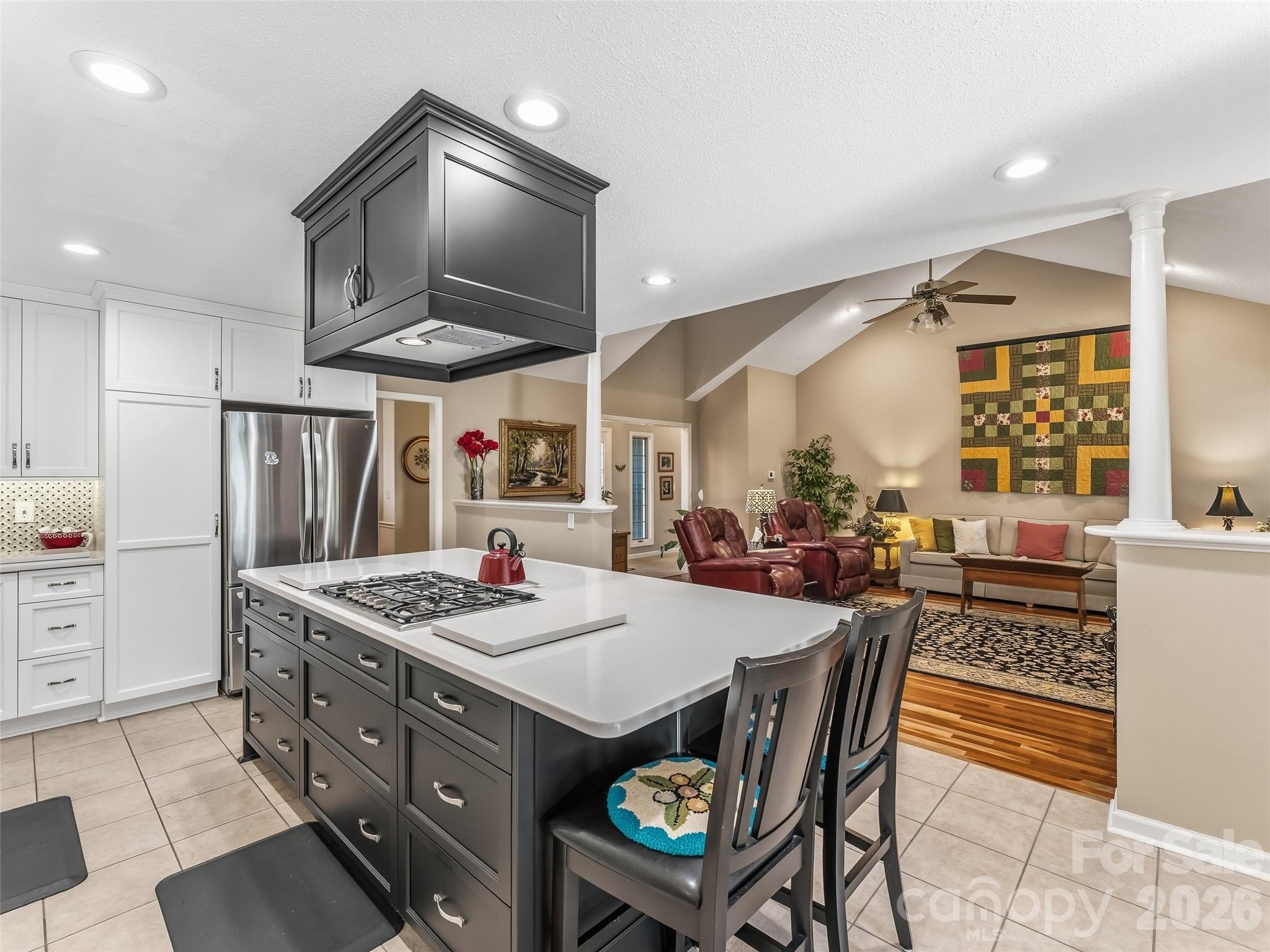 1340 Macedonia Road Saluda, NC 28773 - Photo 16 of 45 a dining hall with stainless steel appliances kitchen island granite countertop a stove a sink a dining table and chairs