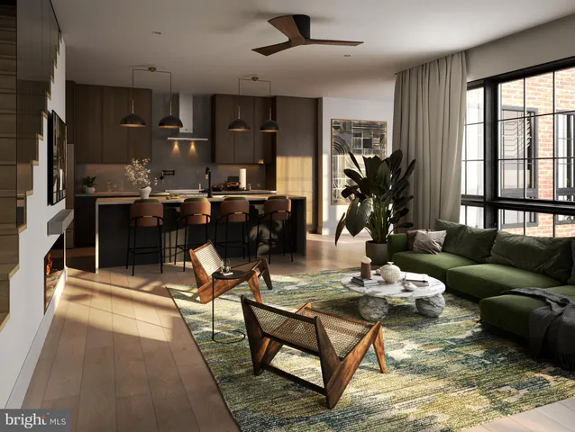a living room with furniture a rug and kitchen view