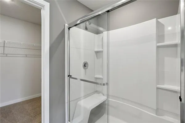 a bathroom with a glass shower door
