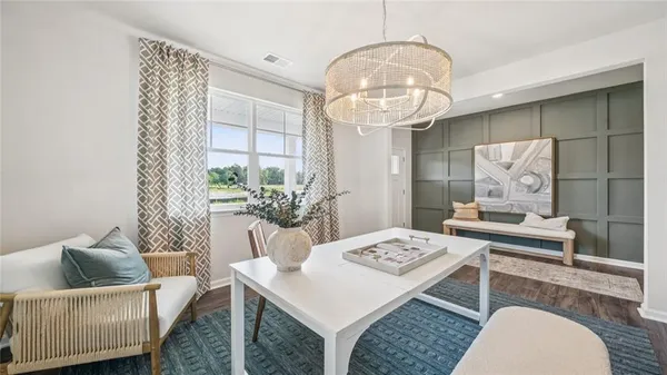 a living room with furniture and a chandelier