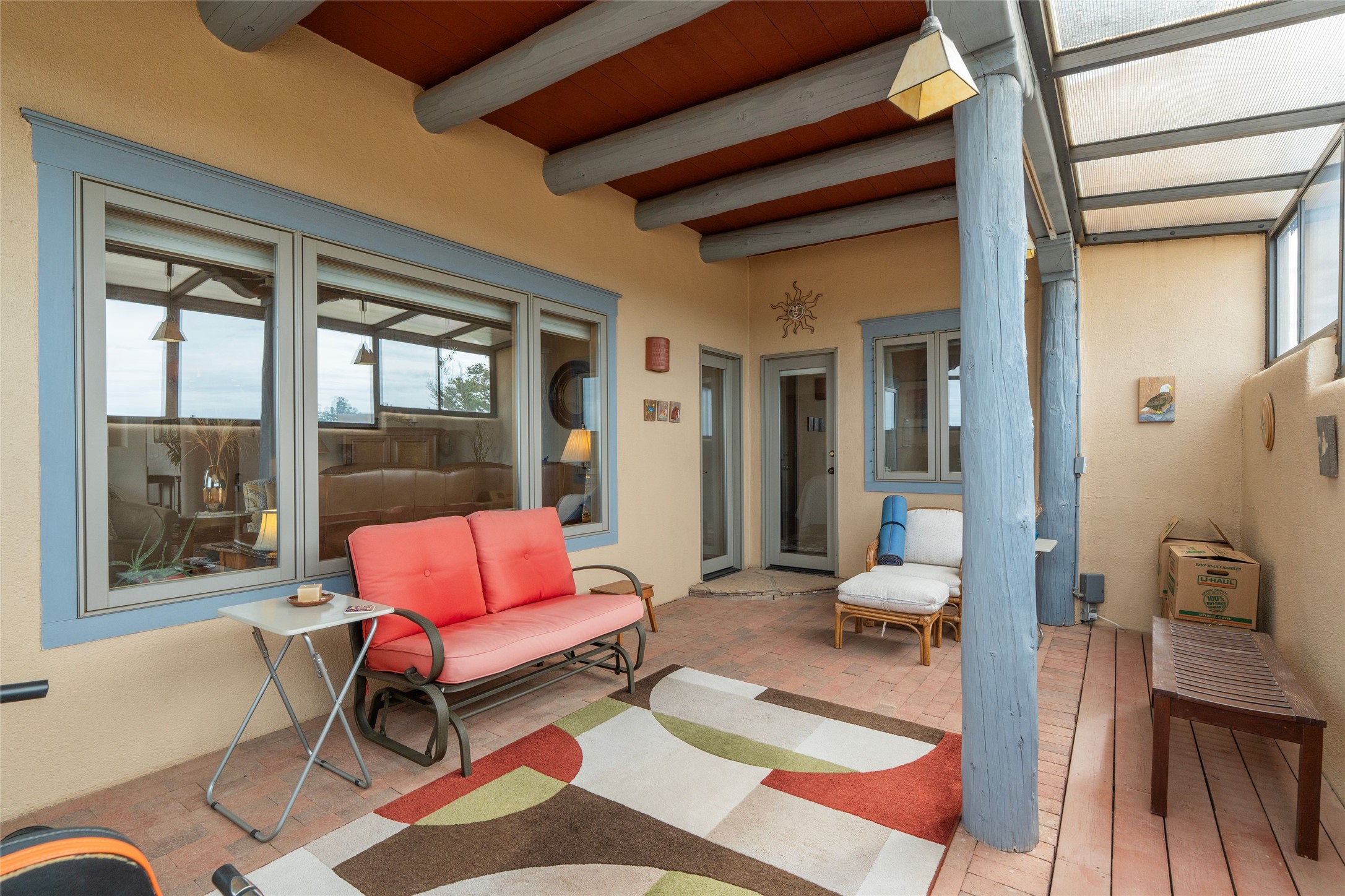 23 Descanso Road Santa Fe, NM 87508 - Photo 25 of 54 Sunroom with brick floors and high ceilings with vigas