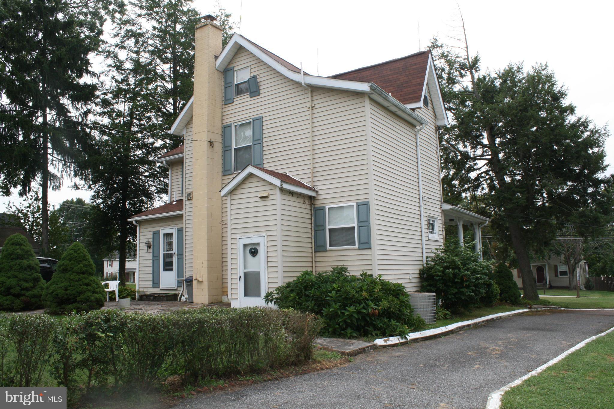 4304 Chapel Road Nottingham, MD 21236 - Photo 9 of 13 a view of a white house next to a yard and trees